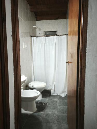 a bathroom with a toilet and a sink at Hostería Michel in Villa Gesell