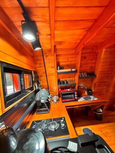 a room with a desk in a wooden room at A Mi Manera Apart in Merlo