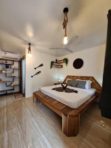 a bedroom with a bed with a wooden bed frame at Tulog 1 in El Nido