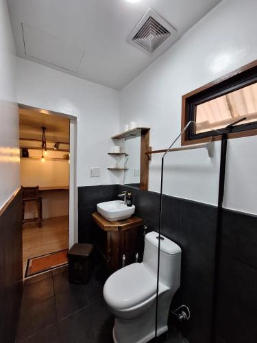 a bathroom with a toilet and a sink at Tulog 1 in El Nido