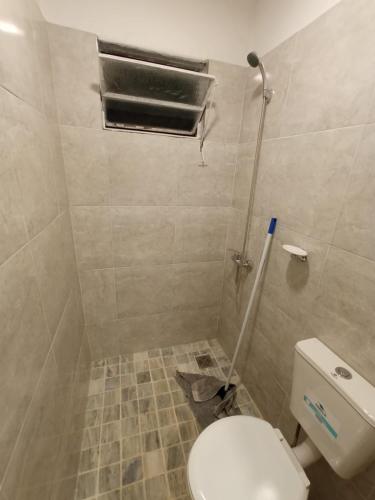 a small bathroom with a toilet and a window at Las Vertientes in Tanti
