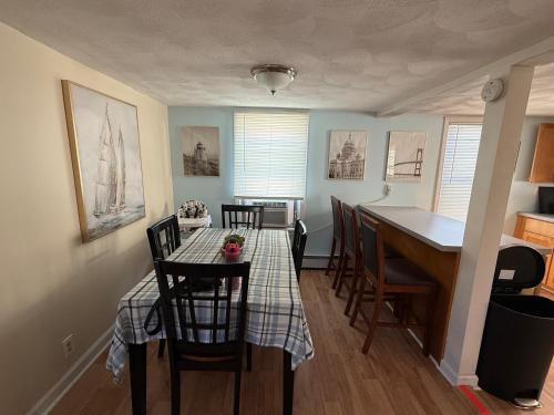 een keuken en eetkamer met een tafel en stoelen bij Oakland Beach Cottage - Sleeps up to 4 in Warwick