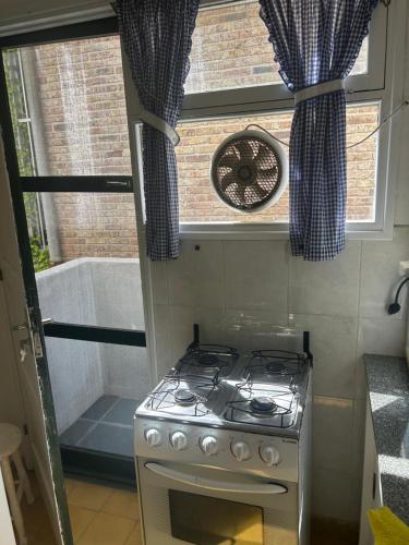 a stove in a small kitchen with a window at Irape in La Paloma
