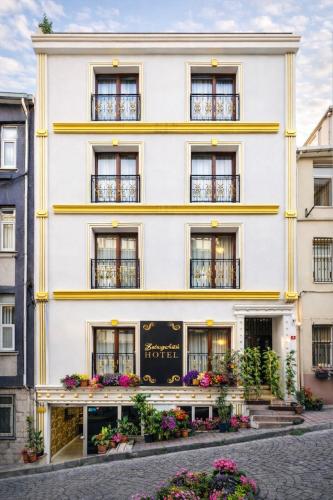 a white building with flowers in front of it at Kadirga Antik Hotel - Sultanahmet in Istanbul
