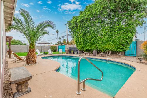 a swimming pool in a yard with a tree at Cozy Tempe Casa with Heated Pool 5 Minutes to ASU in Tempe
