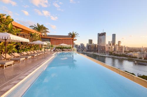 a large swimming pool with a view of the city at Emporium Hotel South Bank in Brisbane
