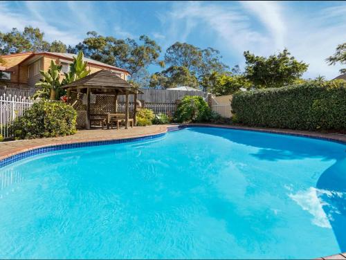 a large blue swimming pool with a gazebo at A 3 bedders close to everything in Brisbane