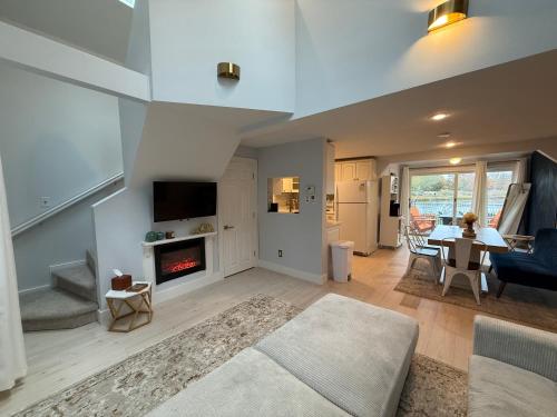 a living room with a couch and a fireplace at Cozy Waterfront Cottage - Sleeps 4 in Warwick
