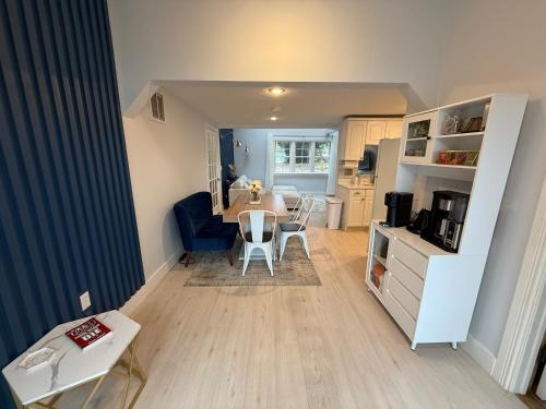 a kitchen and dining room with a table and chairs at Cozy Waterfront Cottage - Sleeps 4 in Warwick