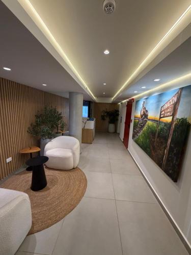 a hospital hallway with a large painting on the wall at Lujoso Apartamento en edificio frente a la playa San José! in Encarnación