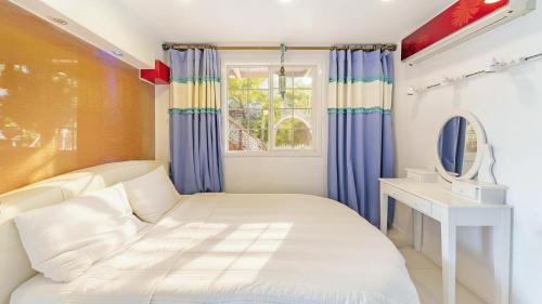 En eller flere senge i et værelse på Gapyeong Belita pension