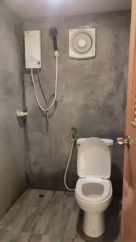 a bathroom with a toilet and a shower at Kohpu garden in Ban Klang