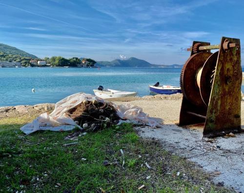 a group of boats on the shore of a lake at Stylish Stone House for Two in Koločep