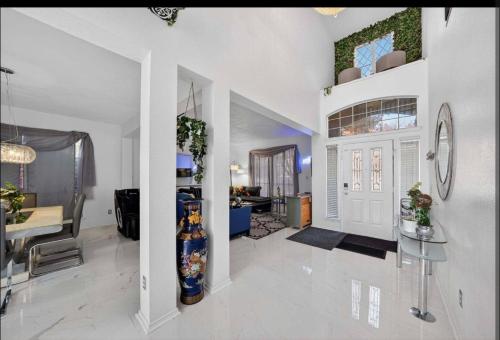 a living room with a white door and a table at Le Monye in Lewisville