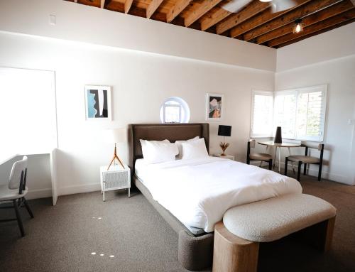 a bedroom with a bed and a table and chairs at Suites by The Wellborn in Orlando
