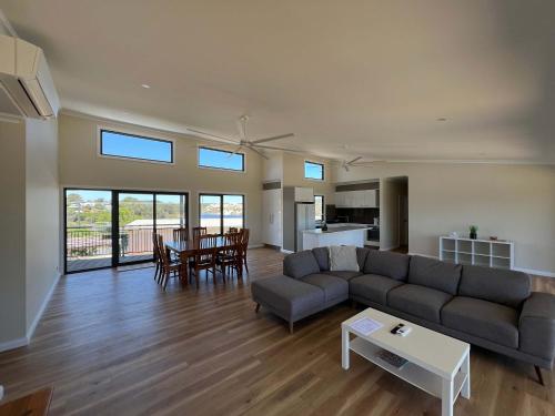 a living room with a couch and a table at Moore Memories Beach House in Guilderton