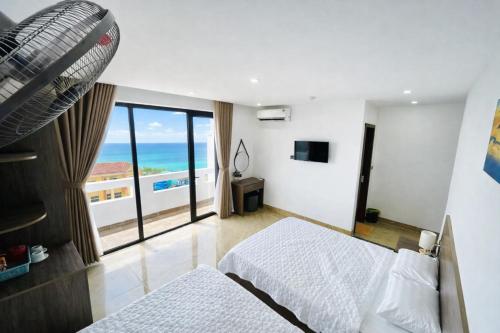a bedroom with a bed and a view of the ocean at Sunrise Hotel Thiên Cầm in Ha Tinh