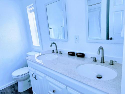 a white bathroom with a sink and a toilet at Cozy Twilight Hideaway in Forks