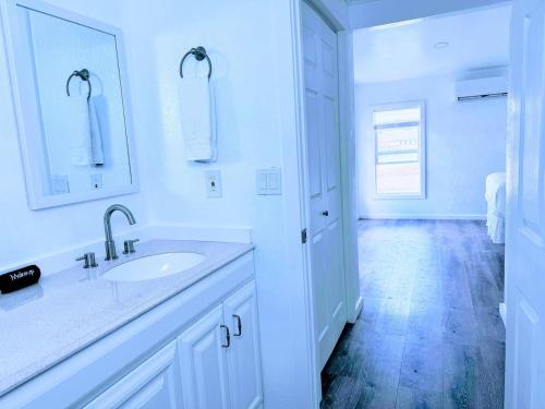 a white bathroom with a sink and a mirror at Cozy Twilight Hideaway in Forks