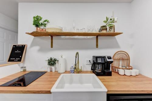 a kitchen counter with a sink and a coffee maker at Independence Bungalow in Wimberley