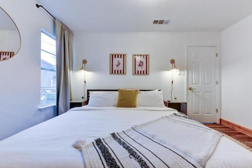 a bedroom with a large white bed with two pillows at Independence Bungalow in Wimberley