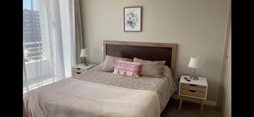a bed with two pillows on it in a bedroom at II Cerca de la playa y del centro in La Serena