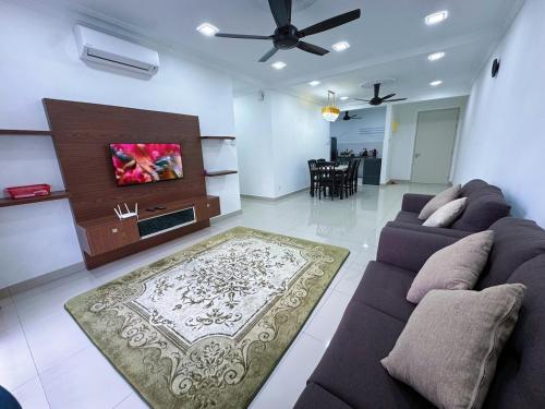 a living room with a couch and a flat screen tv at PICC Seruling Precinct 5, 62200 Putrajaya 3BR Homestay in Putrajaya