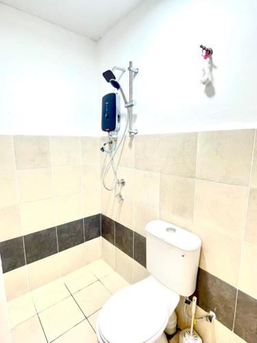 a bathroom with a toilet and a shower at My Homestay in Tuaran