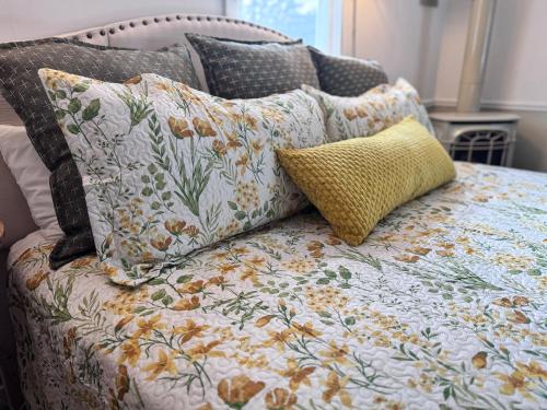 a bed with several pillows on top of it at The Landgrove in North Landgrove