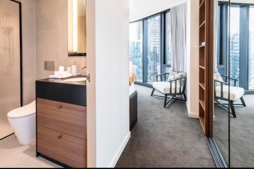 a bathroom with a sink and a toilet and a window at Luxury Apartment with Stunning Southbank Views in Melbourne