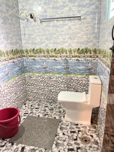 a bathroom with a mural of a river at Malnad cloud homestay Agumbe in Someshwar