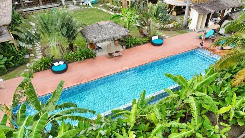 an overhead view of a swimming pool in a resort at RECA Resort Philippines Luxury Villas & Nature Retreat in Porac