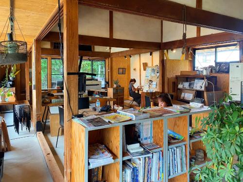 a book store with a counter with books at コワーキングスペース kuzume Base ゲストハウス 古朴-MOKU-1棟貸の宿 in Konan