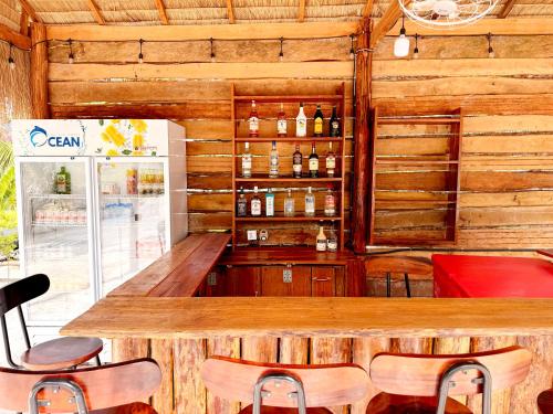 a bar in a restaurant with a wooden wall at Garden Hostel Koh Rong in Koh Rong Island