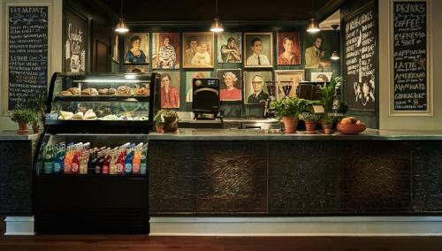 a restaurant with a counter with food and drinks at Graduate by Hilton Ann Arbor in Ann Arbor