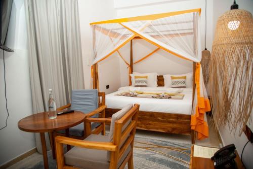 En eller flere senge i et værelse på Bellissimo Boutique Hotel