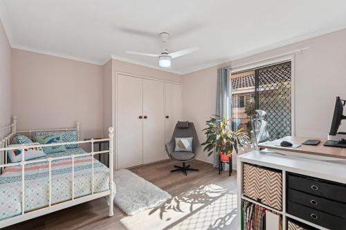 a bedroom with a bed and a desk at Exclusive Living for Professionals in Seacliff