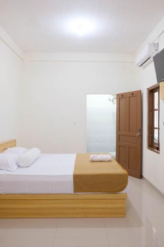 a bedroom with a bed and a door in it at Elmo Living in Yogyakarta