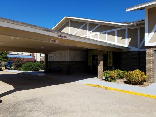 a building with a parking lot in front of it at Super 8 by Wyndham Bentonville in Bentonville