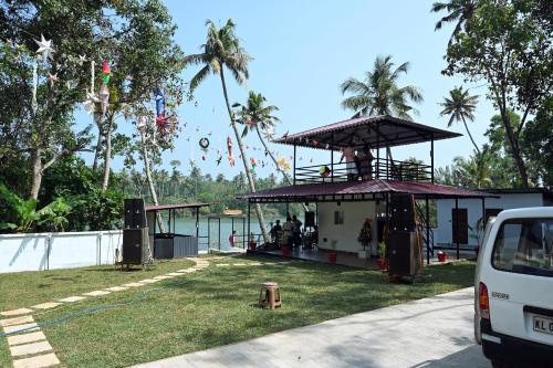 a food stand on the grass next to the water at Orchid Lake View Resort in Paravūr