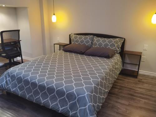 a large bed in a room with a chair at Cozy Suite! Separate Entry, 1 Parking in Newmarket