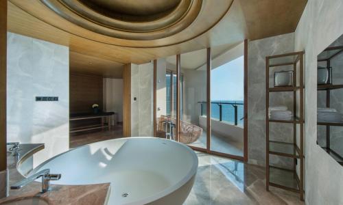 a bathroom with a white sink and a large mirror at DoubleTree by Hilton Shanwei in Shanwei