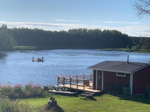 two people in a boat on a lake with a dock at Saagala Village in Tornio