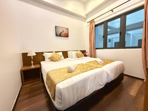 En eller flere senge i et værelse på Nova Mountain n Sunrise view Hilltop Hotel Apartment in Cameron Highlands