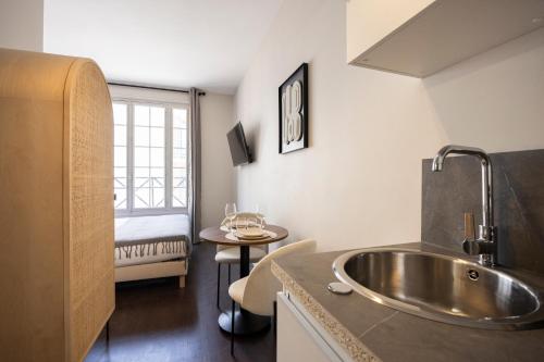 a bathroom with a sink and a room with a bed at Air-conditioned and cozy haven in Le Pré-Saint-Gervais