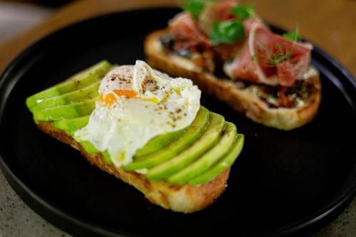 two pieces of toast with an egg on a plate at V Grand Hotel, a member of Radisson Individuals in Medellín
