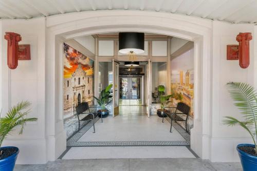 an entrance to a building with a hallway with plants at Hotel 1914 - Historic Alamo Riverwalk, an Ascend Collection Hotel in San Antonio