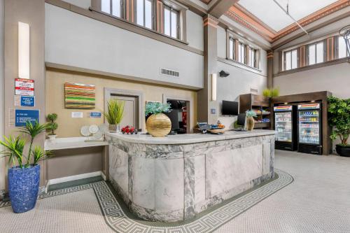 a lobby with a large marble counter in a building at Hotel 1914 - Historic Alamo Riverwalk, an Ascend Collection Hotel in San Antonio
