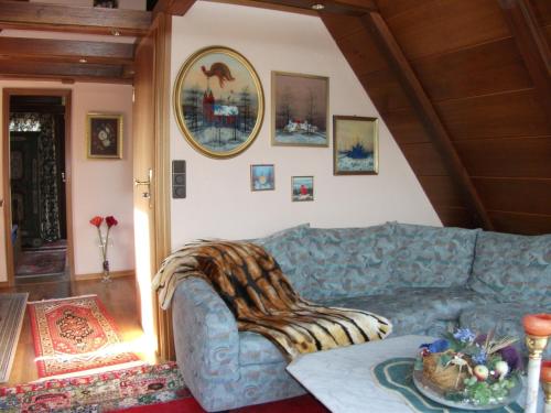 a living room with a blue couch in a room at Paul Lincke Residenz in Hahnenklee-Bockswiese