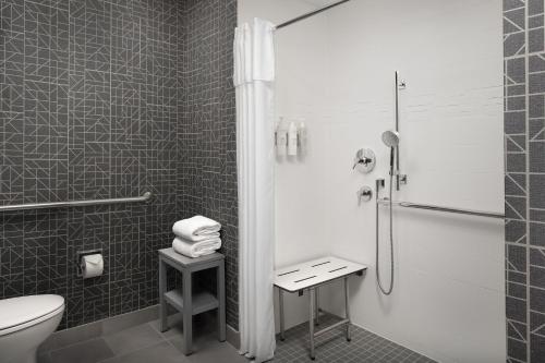 a black and white bathroom with a toilet and a shower at Homewood Suites by Hilton San Antonio Riverwalk/Downtown in San Antonio